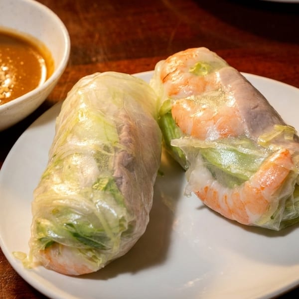 Two fresh spring rolls with shrimp and lettuce, served with peanut dipping sauce.